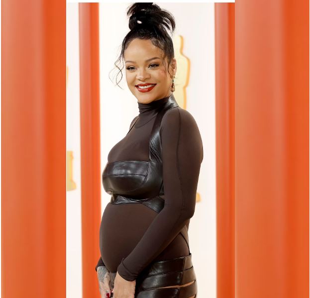 Rihanna puts her baby bump on display as she wows on the 2023 Oscars red carpet