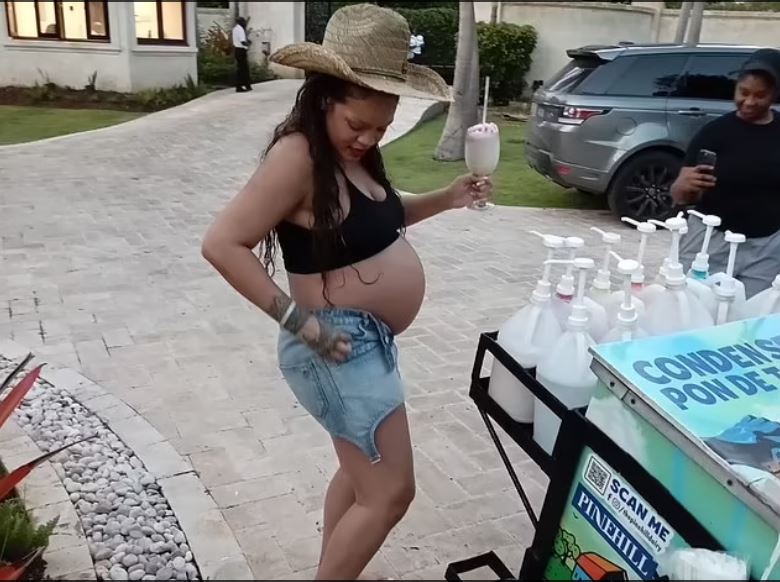 Rihanna displays baby bump as she cools down at her lush villa in Barbados