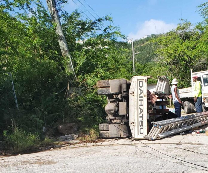 Truck overturns with 4 passengers