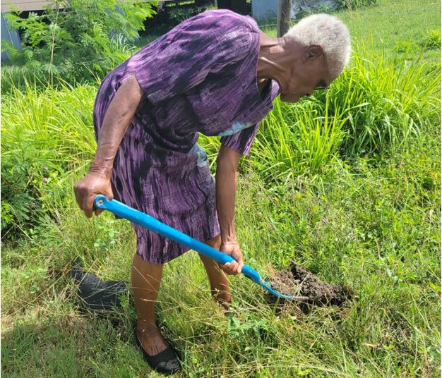 Retired Teacher Celebrates Earth Day by Planting Tree in School Garden